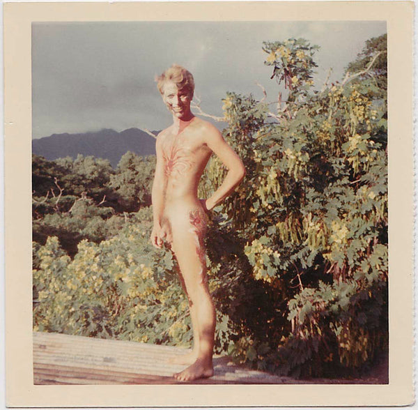 Handsome blond nature boy with colorful body and face paint.  Vintage color snapshot