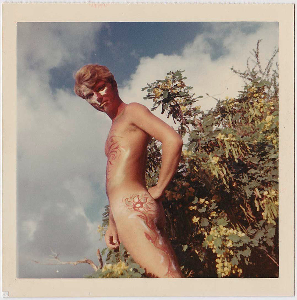 Handsome blond nature boy with colorful body and face paint. Vintage gay color snapshot