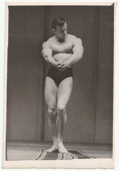 Handsome bodybuilder admires his own physique. Gay interest.
