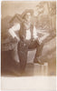 Handsome Cowboy Posing Before Log Cabin vintage sepia real photo postcard