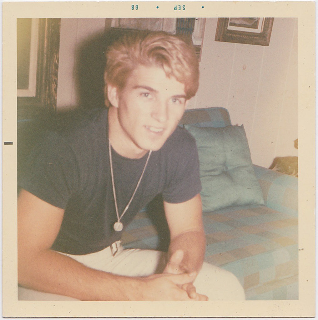 vintage color photo handsome blond guy on sofa