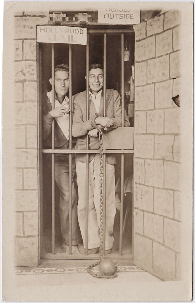 Vintage real photo postcard Two men behind bars in the "Hollywood Jail."