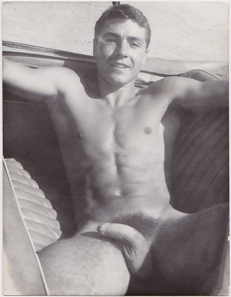 Handsome Jean Pierre Martin lounges in the back seat of a car. Vintage gay photo.