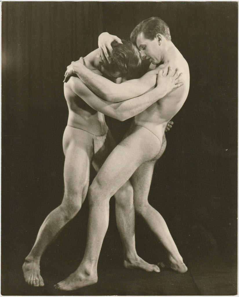 Rare vintage physique photo by John Graham of two models wrestling in posing straps. They're identified on the verso as "Steve & Roger."
