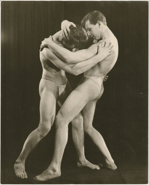 Rare vintage physique photo by John Graham of two models wrestling in posing straps. They're identified on the verso as "Steve & Roger."