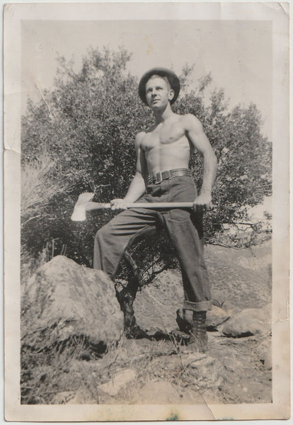 A more conventional view of a handsome and bare-chested man holding an axe. Vintage photo 1939.