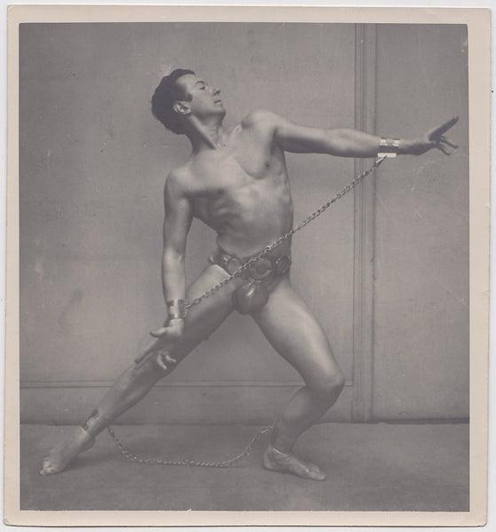 Main in Chains, Vintage physique photo of a lithe model with arms and legs chained c. 1920s.