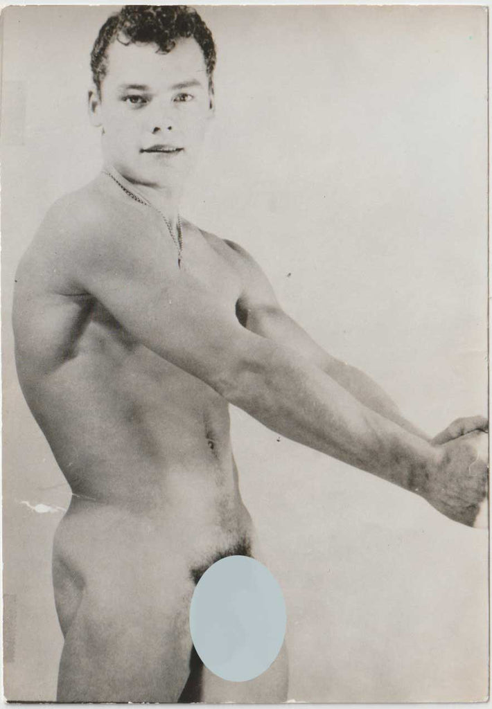 Original vintage gay photo of a young model with his arms outstretched.