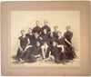 Large format photo of 12 members of an unidentified team relaxing on (wolfskin?) rugs, San Francisco, 1890s.
