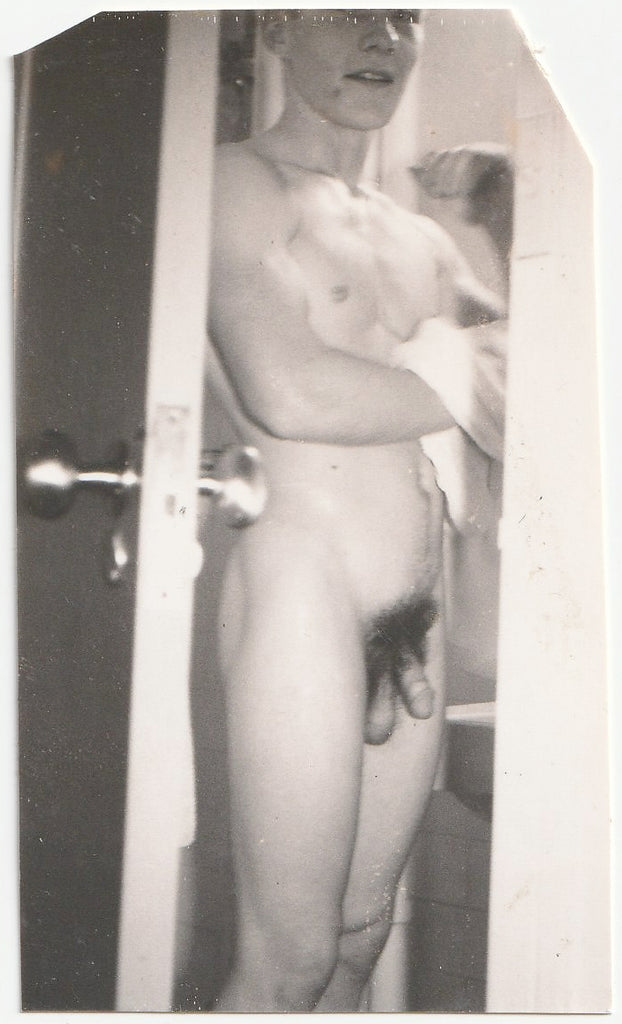 Muscular young guy drying off after a shower. Vintage gay photo