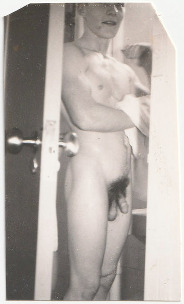 Muscular young guy drying off after a shower. Vintage gay photo