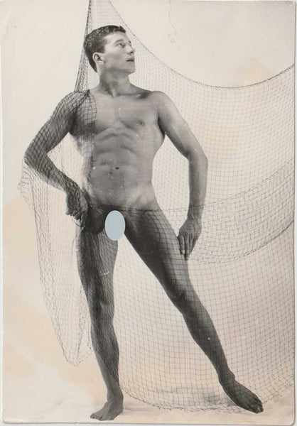 Original vintage photo of a muscular model caught in a net.