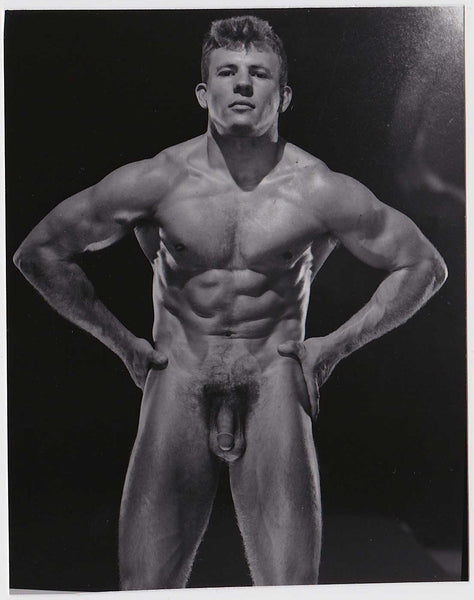 Rugged and ripped male nude stands with his hands on his hips, vintage physique photo gay