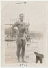 Handsome studly guy sucking in his abs and puffing out his chest. Handwritten on verso: "A guy I knew, Sept 14, 1946, Cuba." 