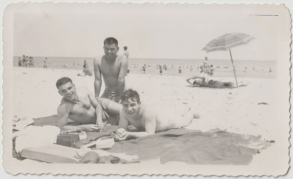 Three young guys on a blanket with their books and what might be a radio vintage snapshot.