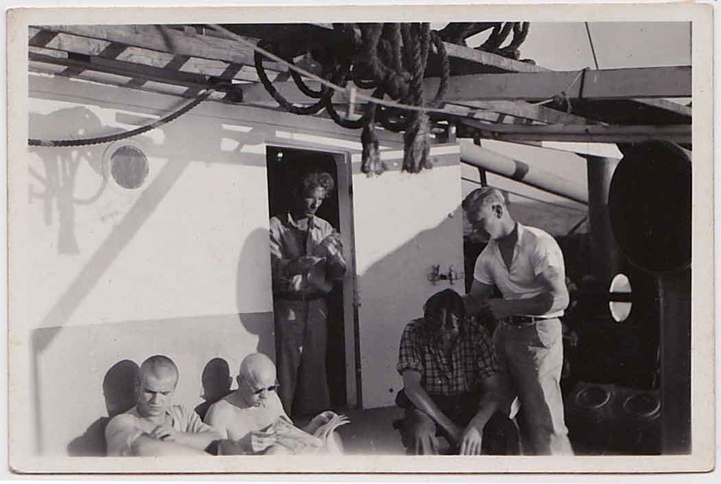 vintage gay snapshot Humpy barber cutting a sailor's hair on deck.