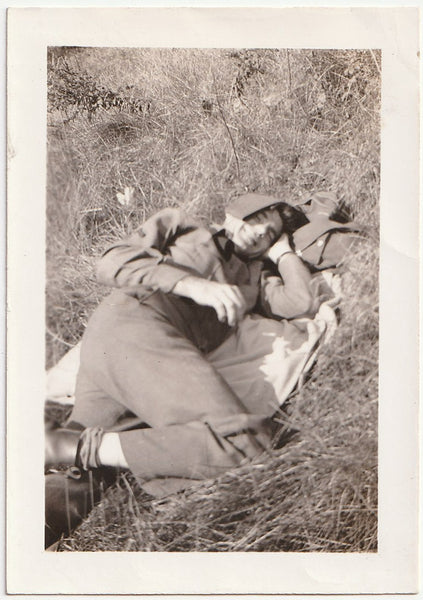 Smiling soldier lying on grass