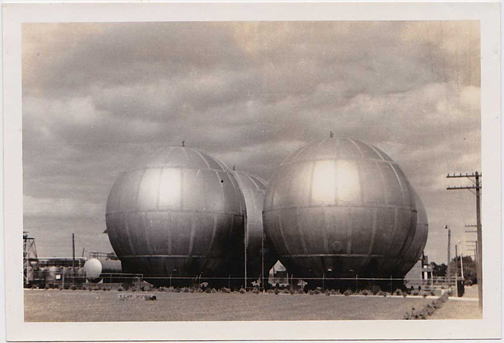 Four giant spherical tanks glowing in the sunshine like a still from some 50s sci-fi movie.