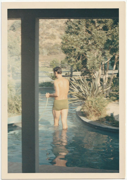 Studly Man Holding Hose vintage color snapshot on Kodak paper, c. 1960s.