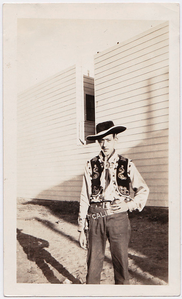 Vintage snapshot cowboy looks a bit like Pee Wee Herman in this decorated and embroidered cowboy couture