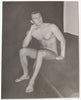 Thoughtful Male Nude sitting on sofa