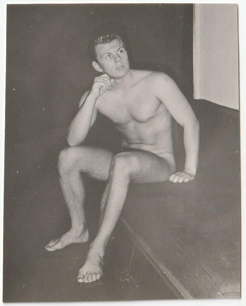 Thoughtful Male Nude sitting on sofa