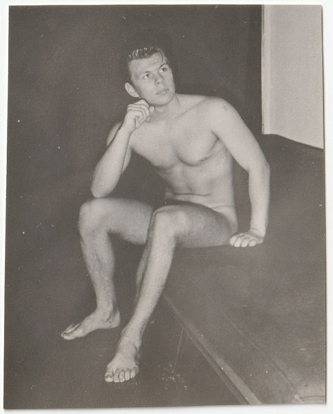 Thoughtful Male Nude sitting on sofa