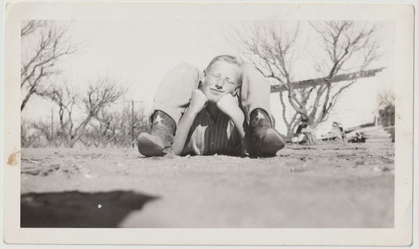 Vintage snapshot worm's eye view of two guys lying in the dirt forming a single, very strange creature.