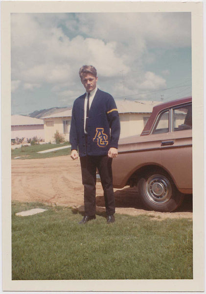vintage color snapshot of a handsome blond jock standing by a car 
