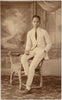 A handsome young man, elegantly attired in a white suit. Real Photo Postcard 1923