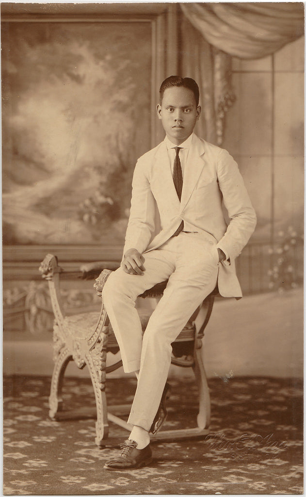 A handsome young man, elegantly attired in a white suit. Real Photo Postcard 1923