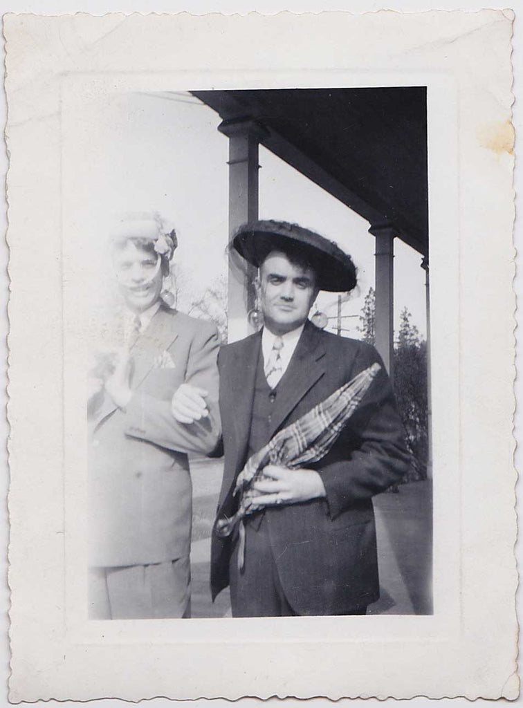 Two men identified on the verso as "Hugh and Lloyd" stand arm in arm, vintage gay snapshot