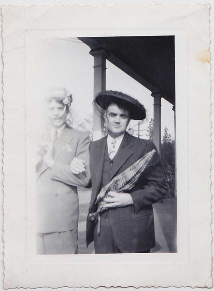 Two men identified on the verso as "Hugh and Lloyd" stand arm in arm, vintage gay snapshot
