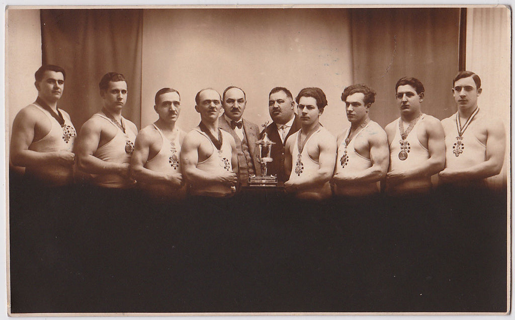 Men in Rows vintage real photo postcard wrestling team with trophy
