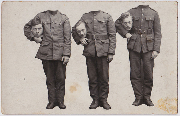 3 decapitated soldiers hold their heads in the crook of their arms