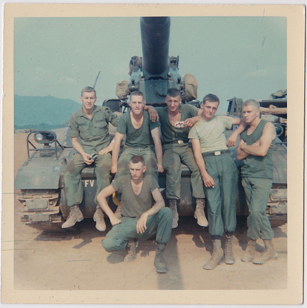 Color snapshot of a six-man tank crew in front of their tank.