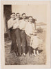 Charming vintage photo of four men posing with a little girl