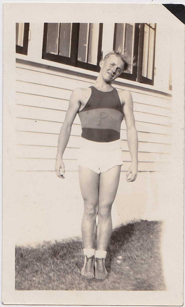 young athlete stands with head tilted and blond hair blowing in the breeze. Vintage snapshot