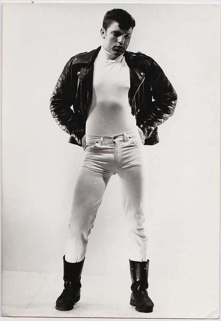 vintage gay photo Glenn Bouy wearing a leather jacket, boots and tight white jeans, by Stan of Sweden.