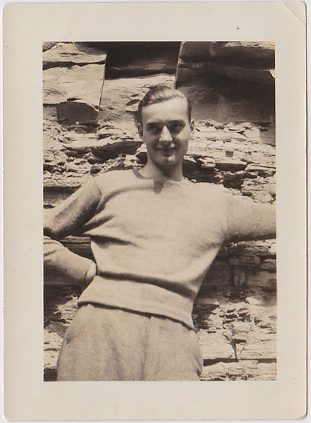 Man strikes an elegant pose in front of rock wall.  Vintage gay snapshot, Aug 22, 1934.