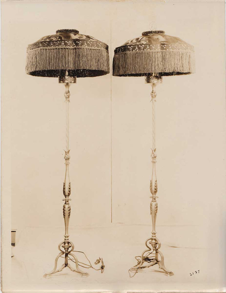 A pair of impressively fringed standing lamps vintage sepia photo