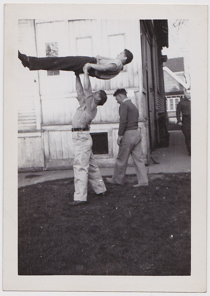 Gymnasts practice in their back yard.    Vintage photo gloss finish, undated c. 1950s.