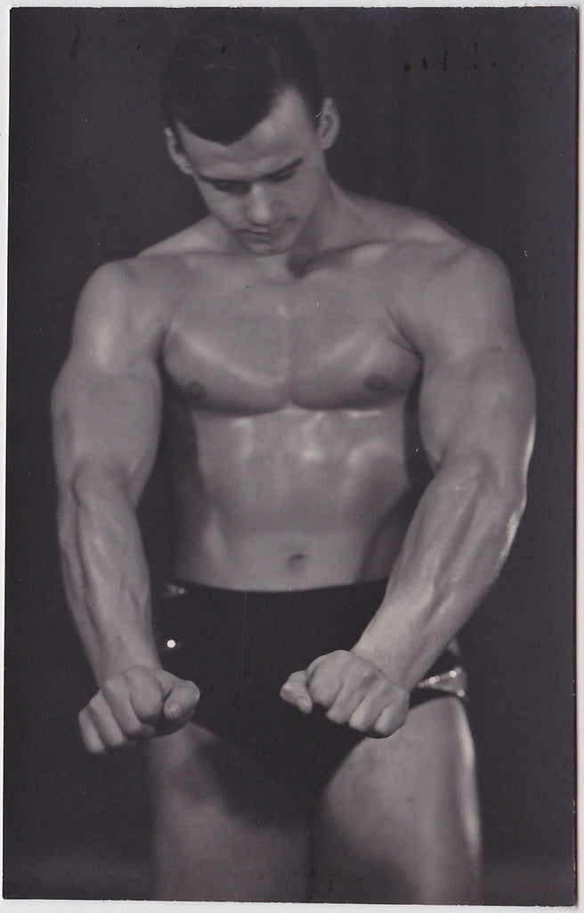 Handsome and muscular bodybuilder shines on stage vintage gay photo
