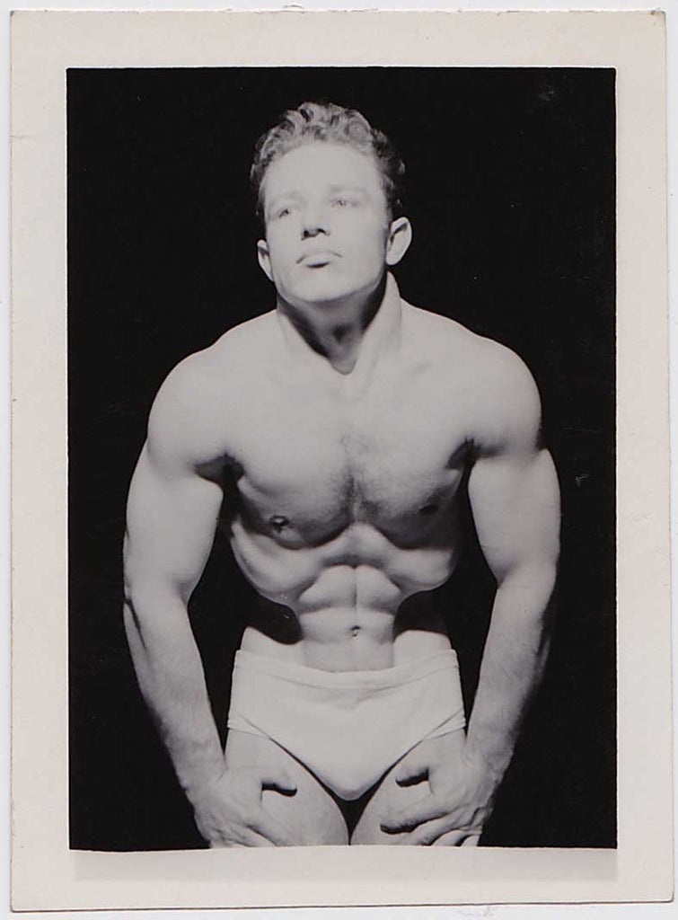 vintage photo Handsome young bodybuilder does a vacuum pose. 