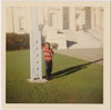 Little kid stands with big guy swagger, resting an arm on some sort of white post. original vintage Kodacolor Print dated Nov, 1967.