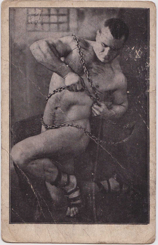 Vintage postcard naked strongman struggles to free himself from chains