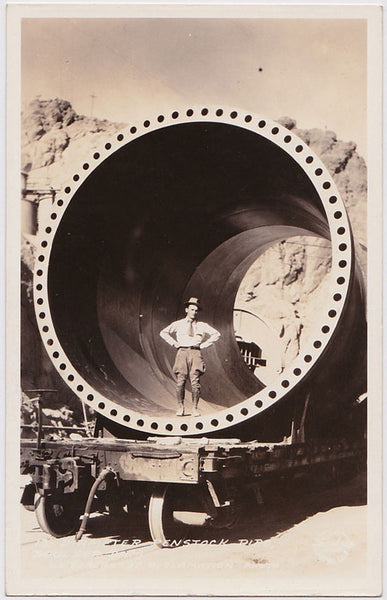 Stunning image of a man wearing jodhpurs standing inside a section of a 13ft diameter "Penstock Pipe" on the construction site of the Boulder Dam (later Hoover Dam).