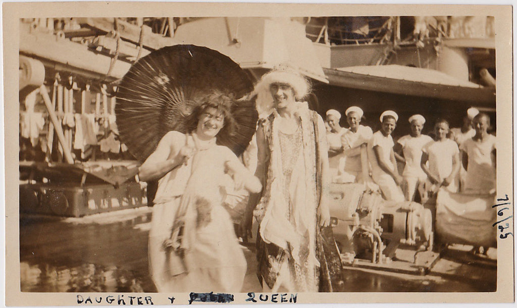 With a gang of smiling sailors in the background the Queen and her daughter yuck it up as they cross the equator vintage photo.