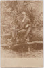 Dapper Man on Fence: Vintage Sepia Real Photo Postcard