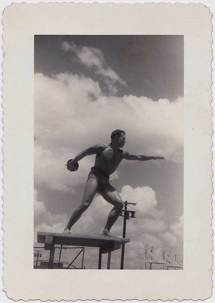 Muscular male athlete stands on a platform with discus in hand vintage gay snapshot